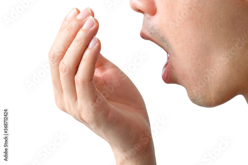 A man uses his hand to protect his cough and sneezing to prevent germs and viruses from spreading. White background . Health and medical concepts