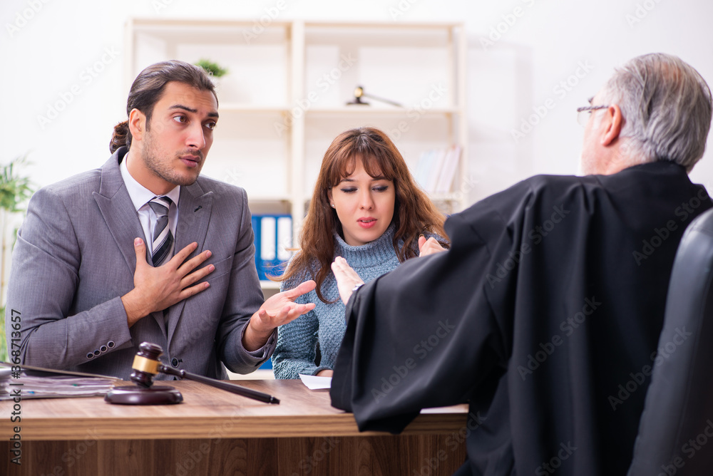 Young woman in courthouse with judge and lawyer Young woman in courthouse with judge and lawyer