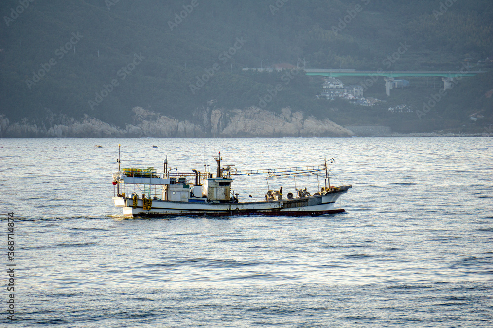 Korean fishing boat sails pass shore line in the internal waters territory