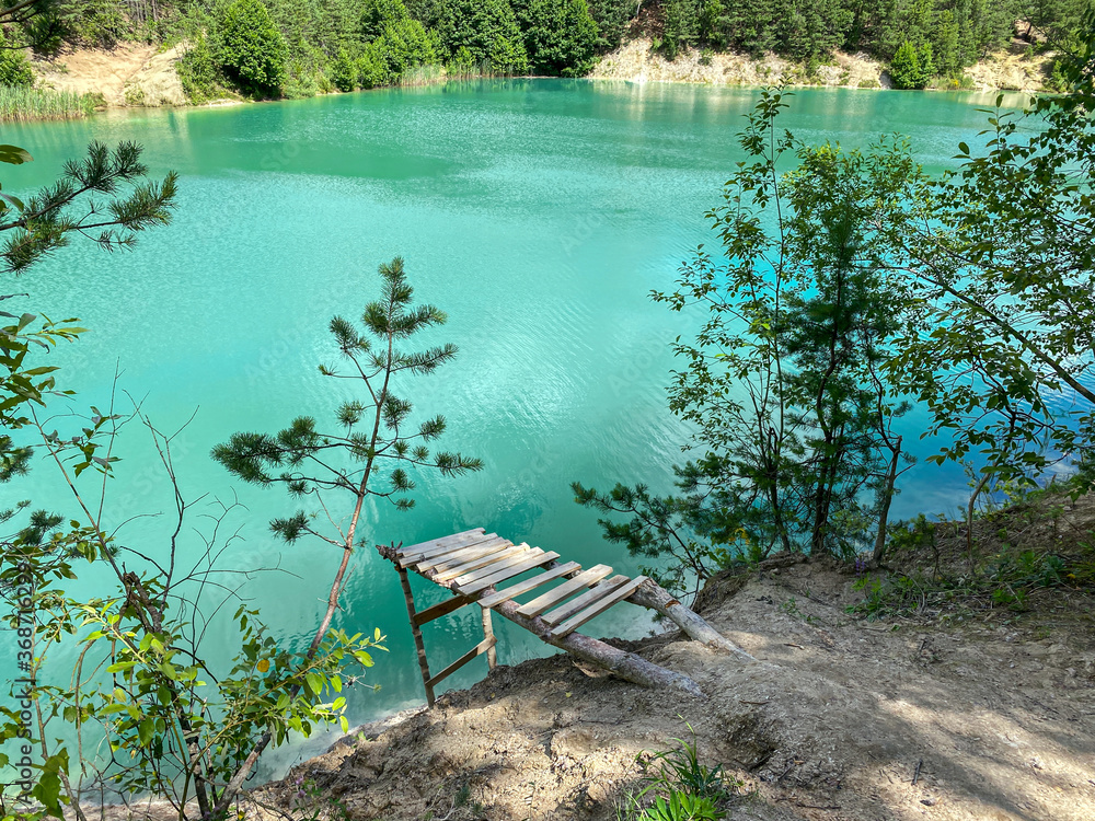 chalk quarry lake with bright turquoise water. sunny summer day landscape