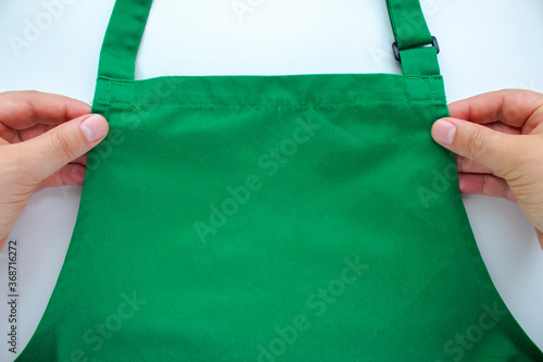 Принти на полотні An person holding an apron on a white background.