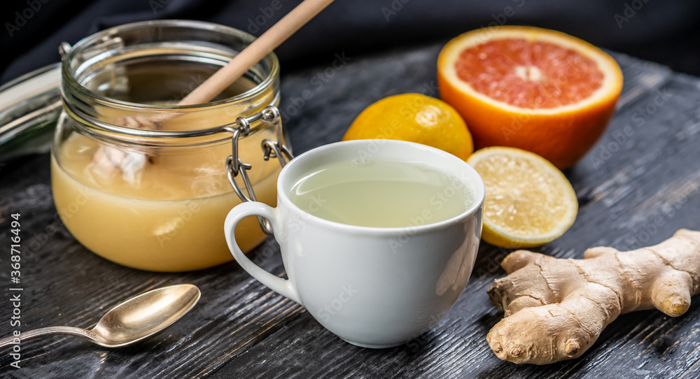 Hot vitamin tea with ginger, lemon and honey. Concept of healthy tea for cold days or a flu Hot vitamin tea with ginger, lemon and honey. Concept of healthy tea for cold days or a flu