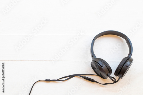 black headphone of listening of lifestyle on background white wooden