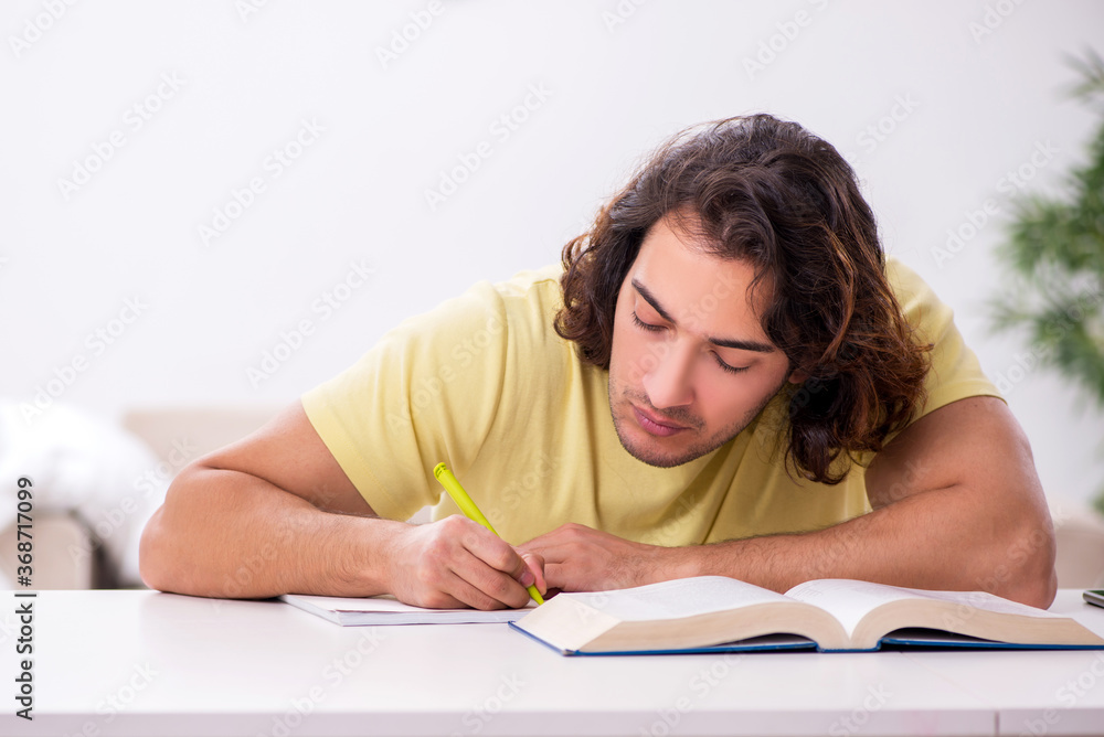 Young male student preparing for exams at home Young male student preparing for exams at home