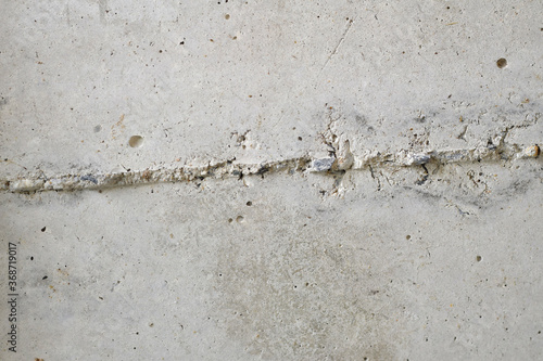 concrete wall surface has gray cracks as the background.