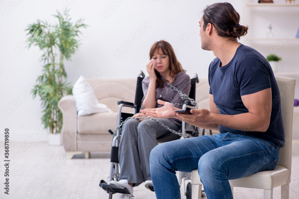 Obraz premium Disabled wife and young husband at home