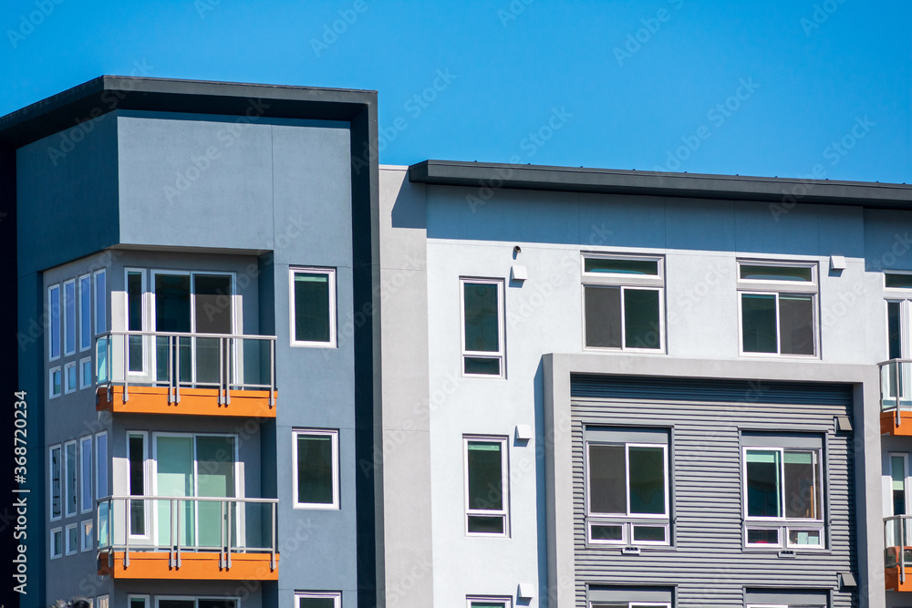 Exterior view of top level floors of typical new multifamily mid-rise residential building Exterior view of top level floors of typical new multifamily mid-rise residential building