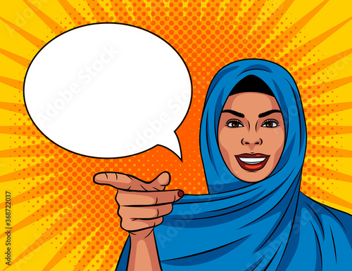 Colored vector illustration in pop art comic style. Beautiful Muslim woman in a traditional shawl on her head. The girl points her finger at you. The woman gestures to you. Arab woman smiling.