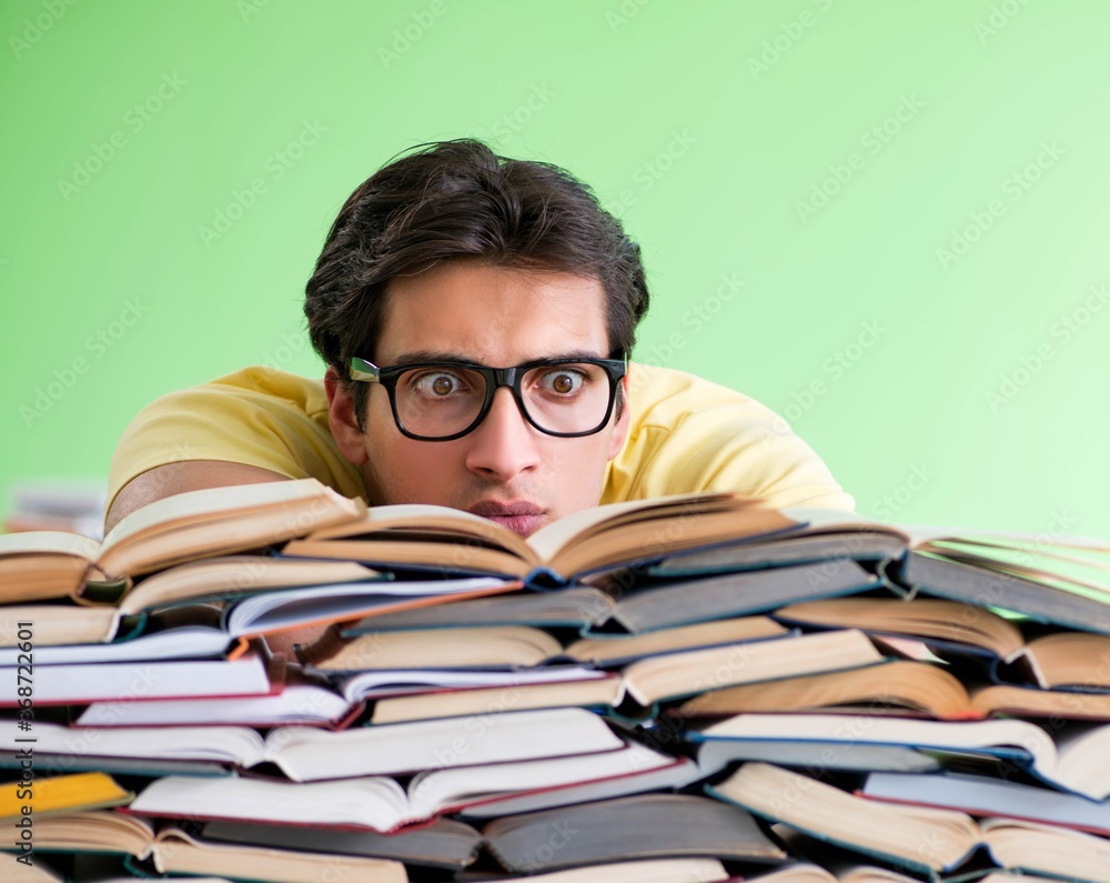 Student with too many books to read before exam Student with too many books to read before exam
