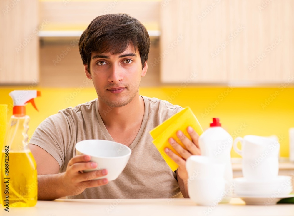 Man washing dishes at home Man washing dishes at home