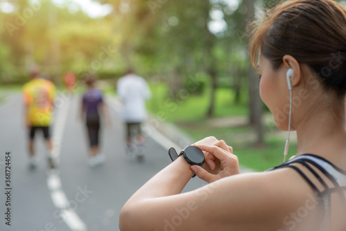 Woman setting up smart watch for running