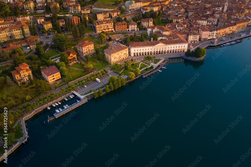 Obraz premium Aerial view of Lake Iseo at sunrise, on the left the city of lovere which runs along the lake,Bergamo Italy.
