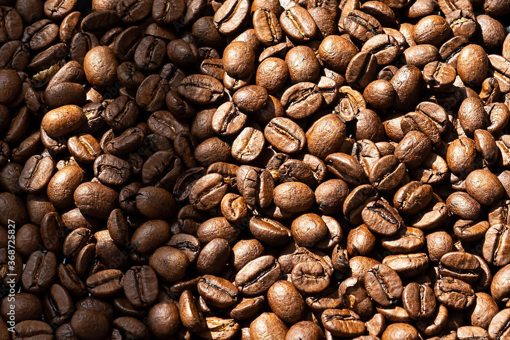 Very beautiful background of roasted coffee beans in the sun Very beautiful background of roasted coffee beans in the sun