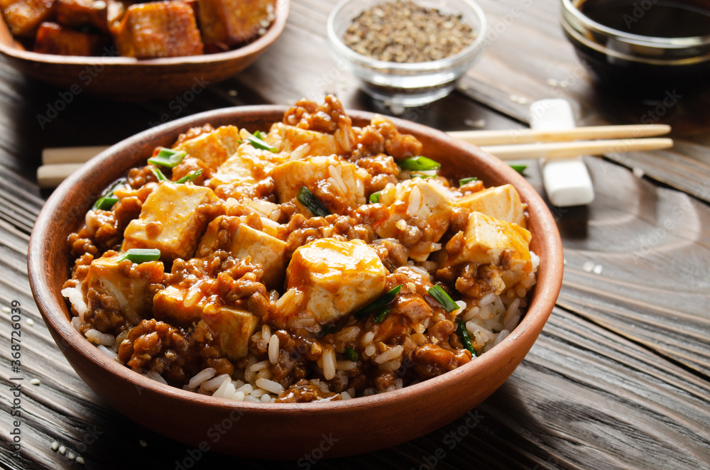 Authentic traditional Chinese food mapo tofu dish with pork chives steamed rice soy sauce and spices closeup Authentic traditional Chinese food mapo tofu dish with pork chives steamed rice soy sauce and spices closeup