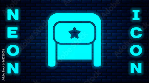 Glowing neon Ushanka icon isolated on brick wall background. Russian fur winter hat ushanka with star. Soviet Union uniform of KGB and NKVD. Vector.