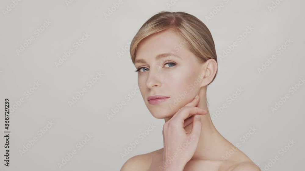 Studio portrait of young and beautiful woman over grey background Studio portrait of young and beautiful woman over grey background