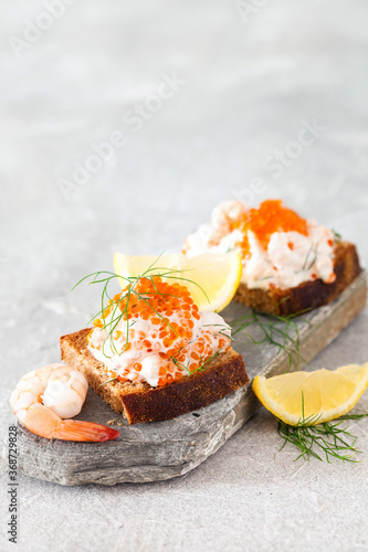 Toast skagen - shrimp and caviar on toast. Classic swedish appetizer. Selective focus. Copy space photo