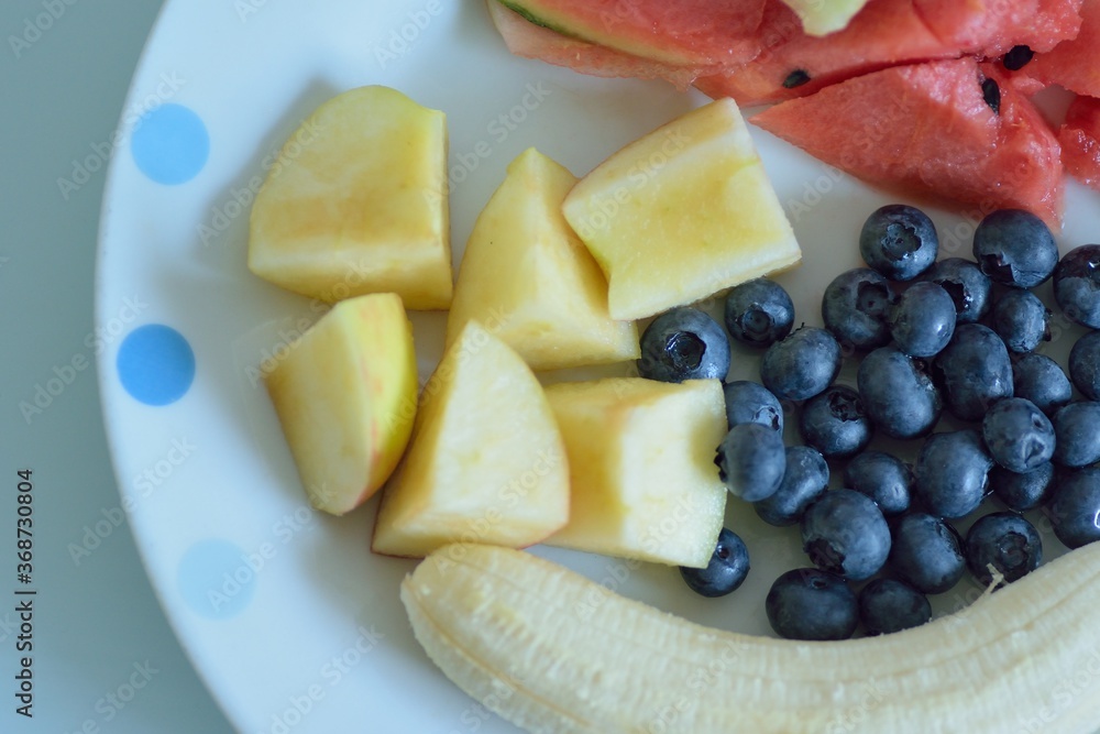 Food background of fruit salad in while plate