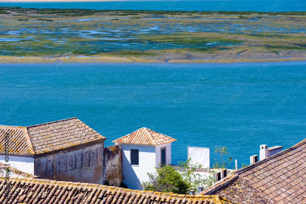 tiled roof and lagoon Ria Formosa in Faro, Algarve, Portugal