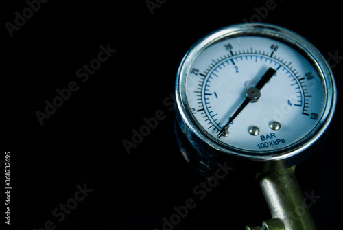 Blur image of tire pressure monitoring equipment, indicator hand, on a black background photo