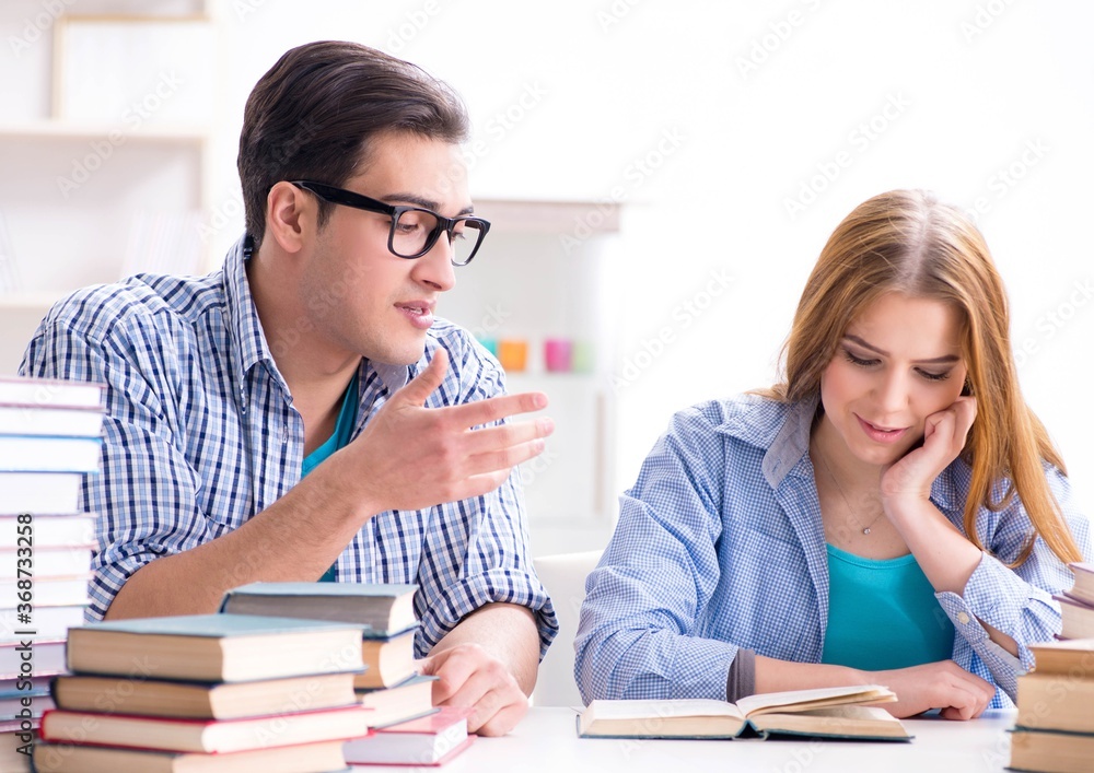 Pair of students studying for university exams Pair of students studying for university exams