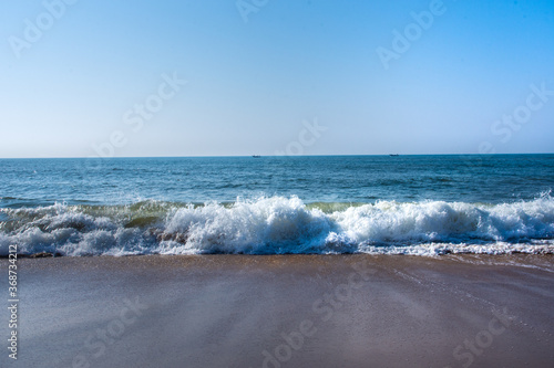 Beautiful Goa Sea beach and water waves at the time of Sunset. photo