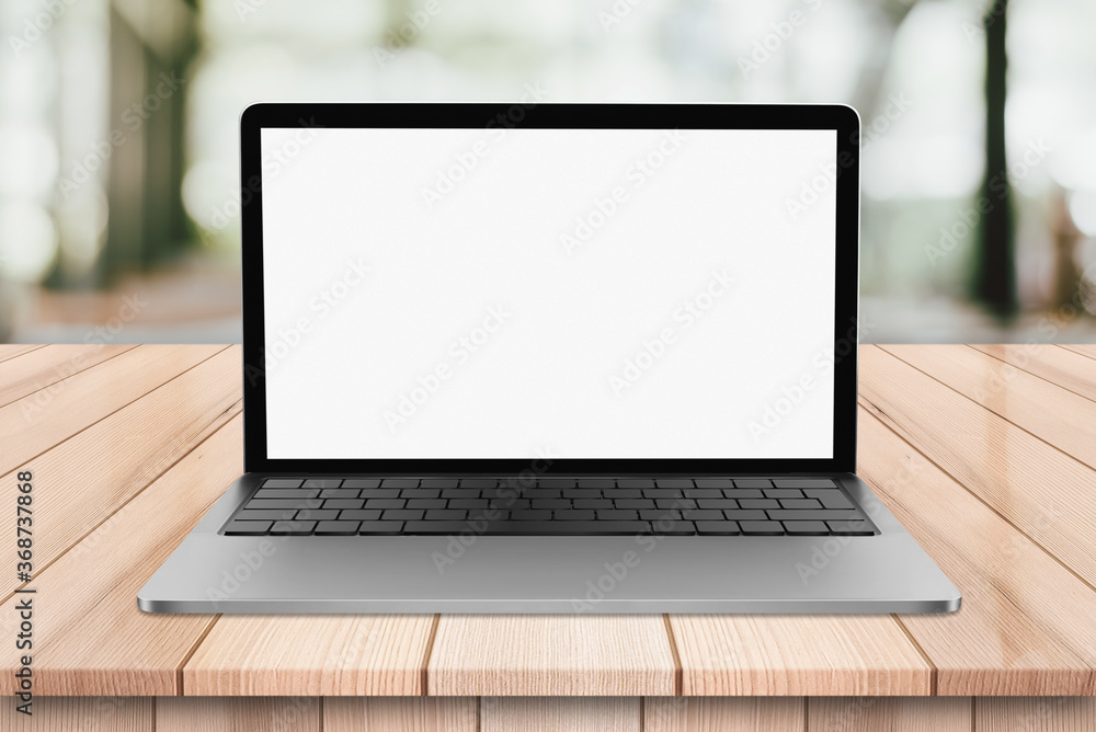 Laptop with blank screen on wooden table with bokeh restaurant backgound Laptop with blank screen on wooden table with bokeh restaurant backgound