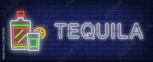 Tequila neon text with bottle and glass. Mexican alcoholic drink design. Night bright neon sign, colorful billboard, light banner. illustration in neon style. photo