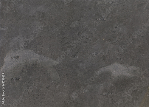 Black stone texture surface. Stone sample from India