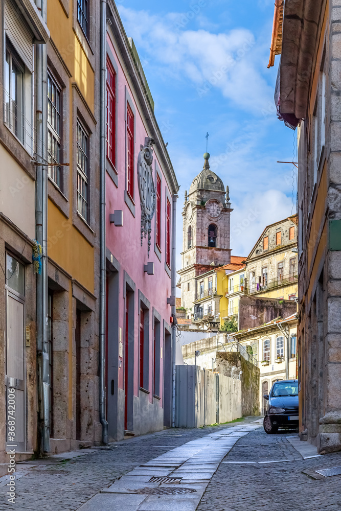 Porto, Portugal. Narrow street in the old town leading to the church, colourful historical houses.