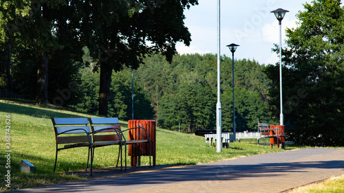 Park and walking paths in Moletai. Lakeside paths. Park benches. Bridges and piers by the lake. A place for walking and relaxing. Lakeside and beaches. Walks outside Architectural elements of the park photo