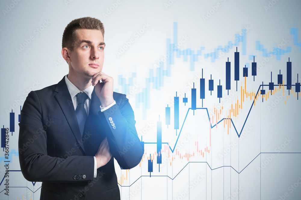 Thoughtful young businessman, financial graph Thoughtful young businessman, financial graph