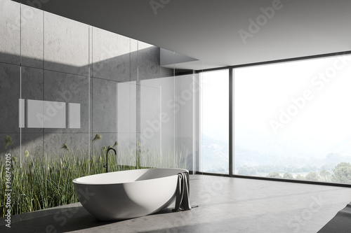 Grey and stone bathroom corner with tub  window