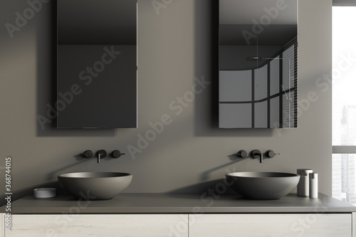 Two round sinks in grey bathroom