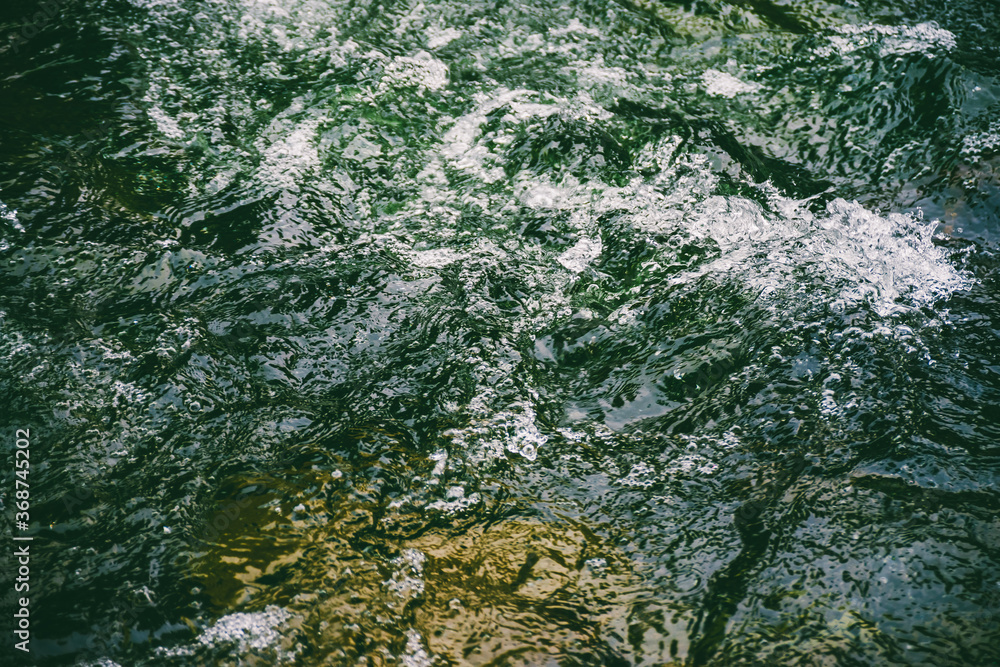 Green water surface with bubbles close-up. Background of green soda drink water. Nature texture of sea surf. Refreshing mint drink with vitamins. Natural backdrop of ocean surf. Fortified water. Green water surface with bubbles close-up. Background of green soda drink water. Nature texture of sea surf. Refreshing mint drink with vitamins. Natural backdrop of ocean surf. Fortified water.