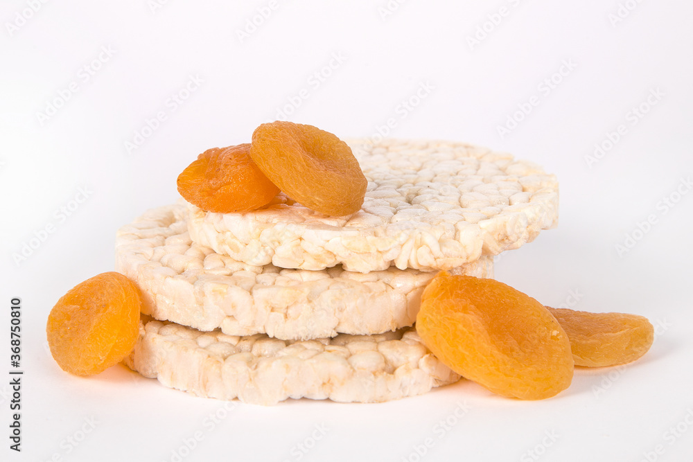 Rice biscuits with a kuraga on a white background. Rice biscuits with a kuraga on a white background.