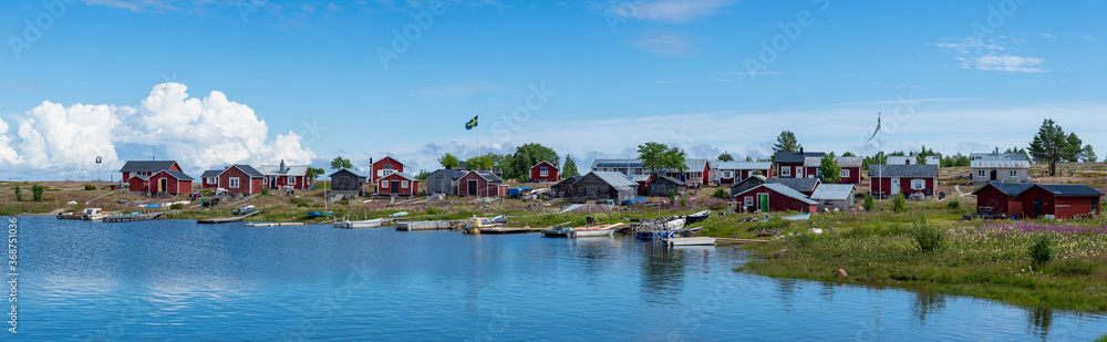 Traditional Fishing Village and Boat houses by the lake in Sweden on Stor-Rabben Island, Near Pitea in the Archipelago of Gulf of Bothnia in Northern Scandinavia. Traditional Fishing Village and Boat houses by the lake in Sweden on Stor-Rabben Island, Near Pitea in the Archipelago of Gulf of Bothnia in Northern Scandinavia.