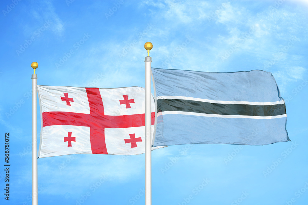 Naklejka premium Georgia and Botswana two flags on flagpoles and blue sky