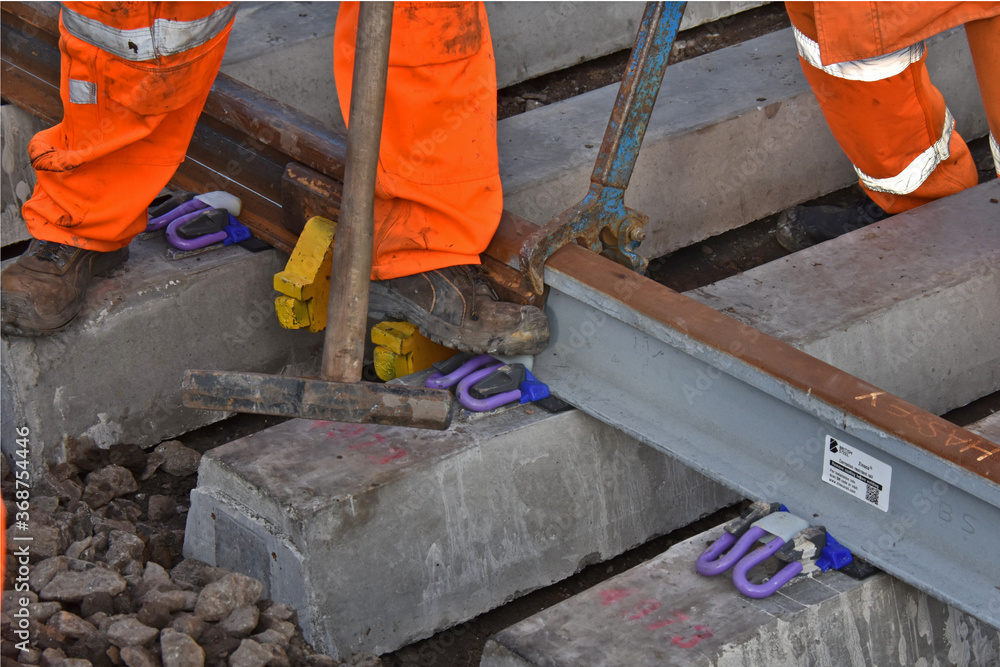 a pandrol type clip being installed on a new section of rail track