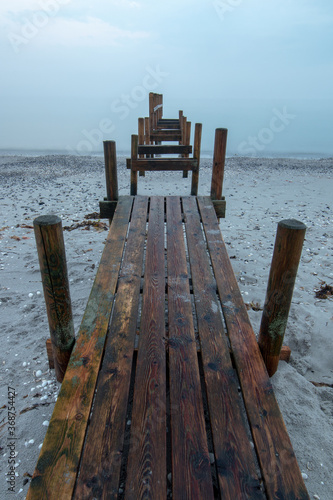 abandoned wooden pier on the beach