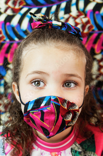 little girl in carnival mask