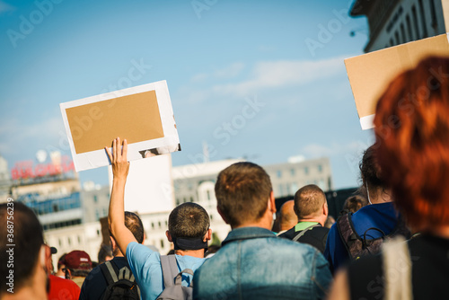 People protesting with signs on the city streets. Manifestation of activists. 