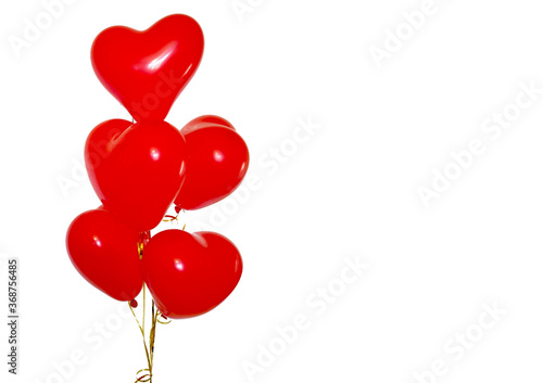 Photo of red glossy heart balloons on a white background horizontally. Valentine's day romantic elegant 14 February card. Birthday. Empty space for party, social media banner promotion, posters