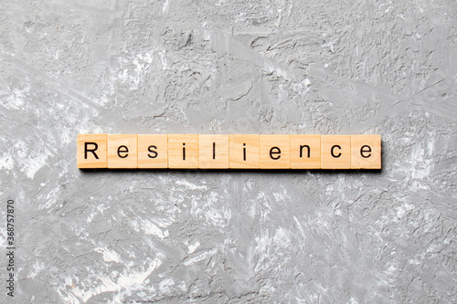 resilience word written on wood block. resilience text on table, concept