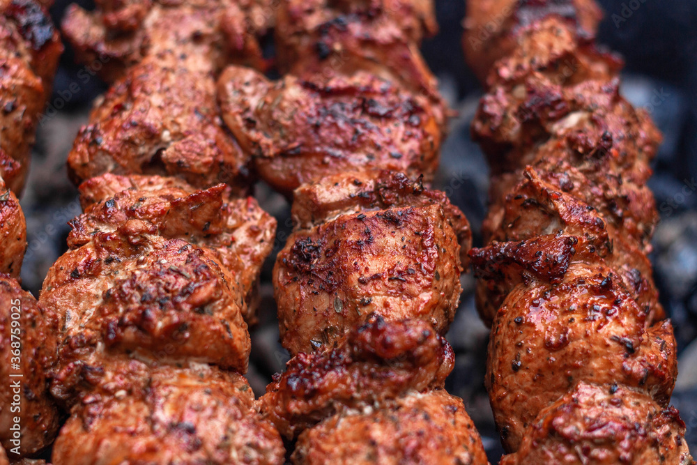 Delicious shish kebab is prepared on the grill