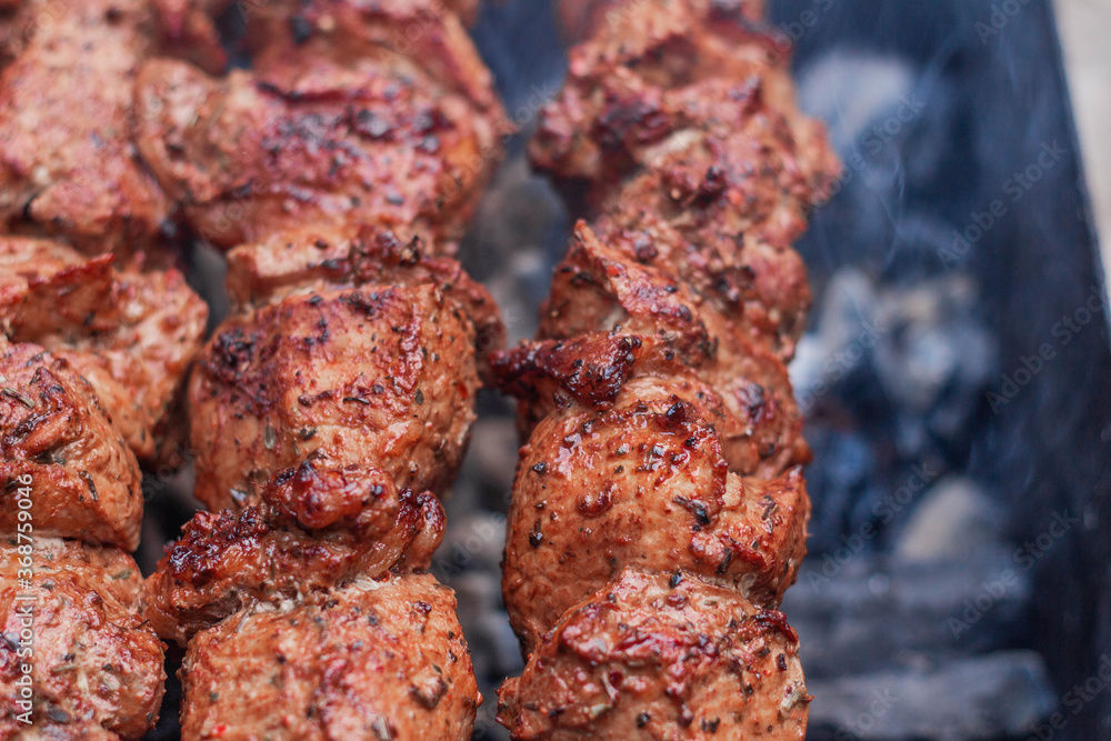 Meat on skewers is cooked on hot coals Meat on skewers is cooked on hot coals
