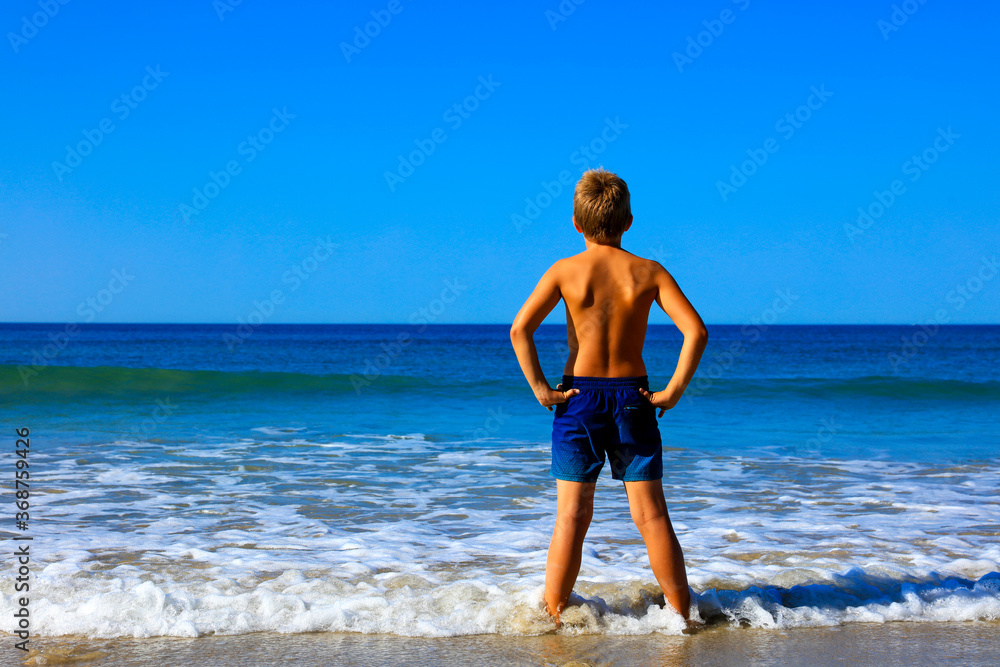 boy, foot on the sea- beautiful beach