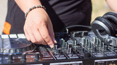 dj at work, dj mixing music on a mixer, hands of dj