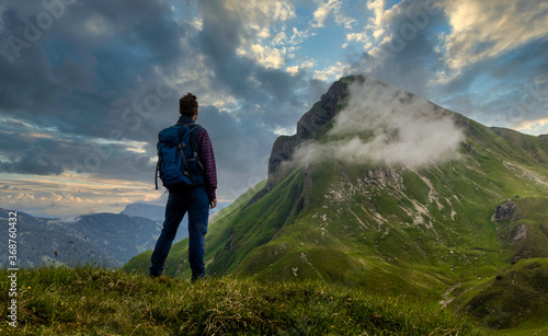 Hiker in Austrian Alps with dramatic sky / Wanderer in Tiroler Alpen mit Blick auf die Rote Spitze bei dramatischen Wolken 