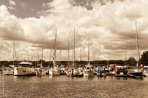 Fototapeta Naklejka Na Ścianę i Meble -  Yacht boats docking in port at Niegocin and Kisajno lake. View at marina. Visiting Masuria in Poland.